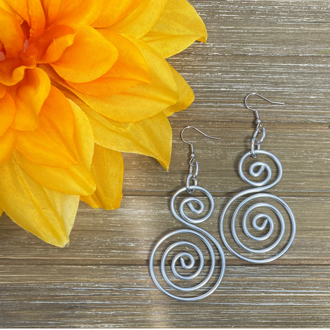 Double Spiral Earrings on woodgrain.webp